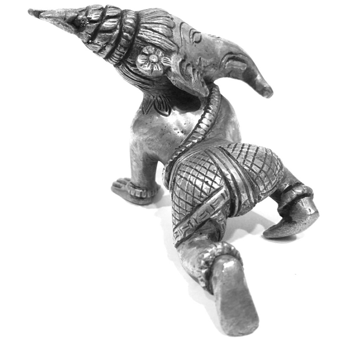 Bal Ganesh statue crawling, top-front view showing tiered topknot and raised hand