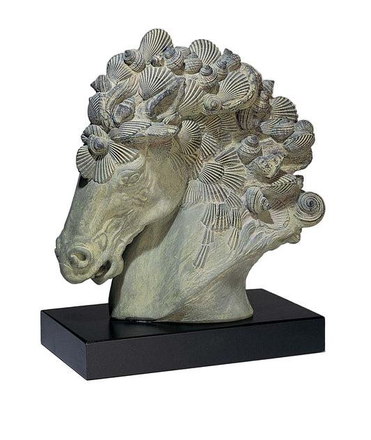 Stone sculpture of a horse head with shell-like decorations on a gray background