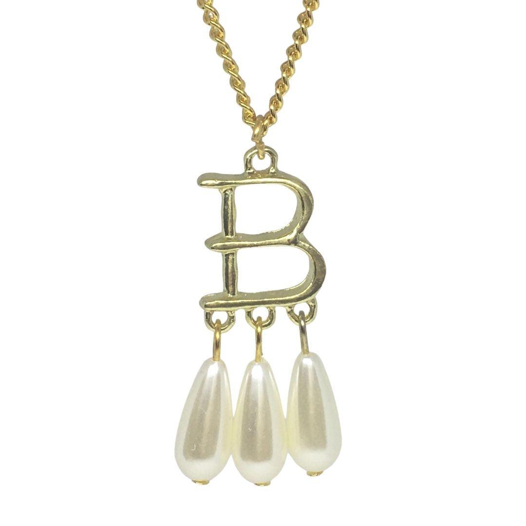Anne Boleyn gold necklace with 'B' pendant and three pearl drops on white background.