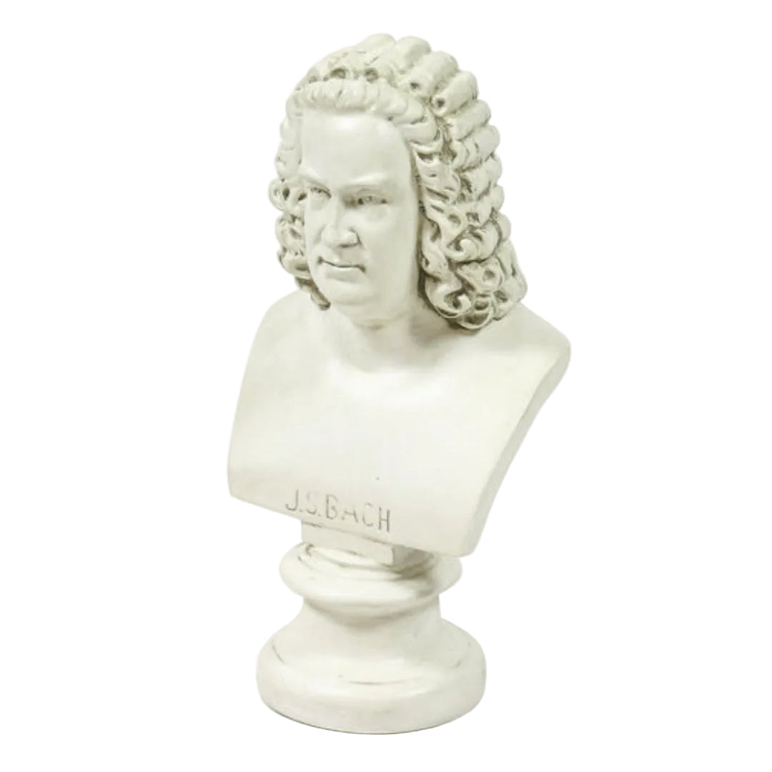 A white plaster bust sculpture of J.S. Bach with curly hair, mounted on a round pedestal base.