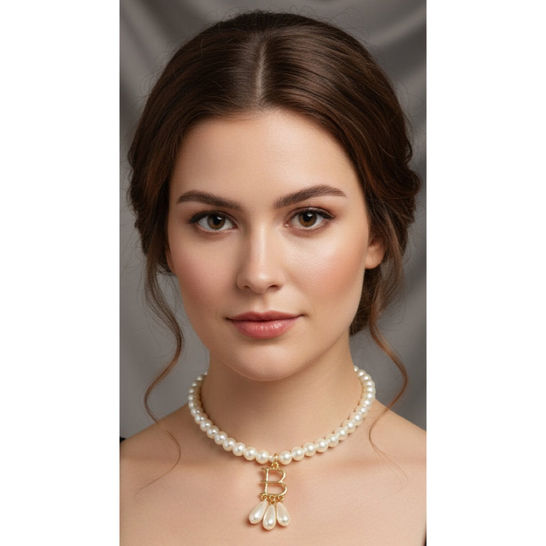 Woman wearing a pearl necklace with a gold pendant with letter B like Anne Boleyn.