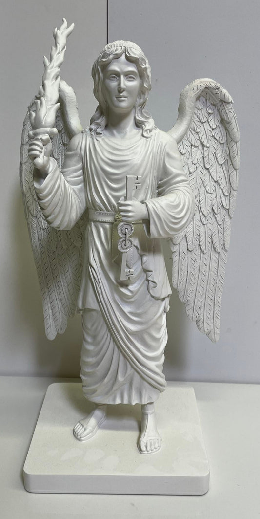 White angel statue with wings and a robe on a white platform against a light gray background