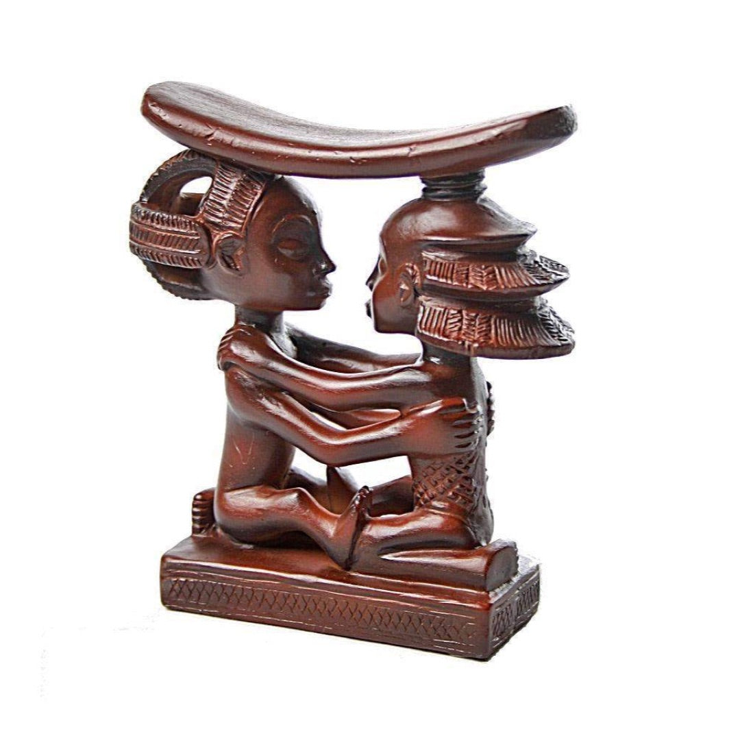 Side view of Luba Congo headrest AFR04 showing one figure with basket hairstyle and stacked disc headdress supporting curved neck rest, Central African sculpture replica