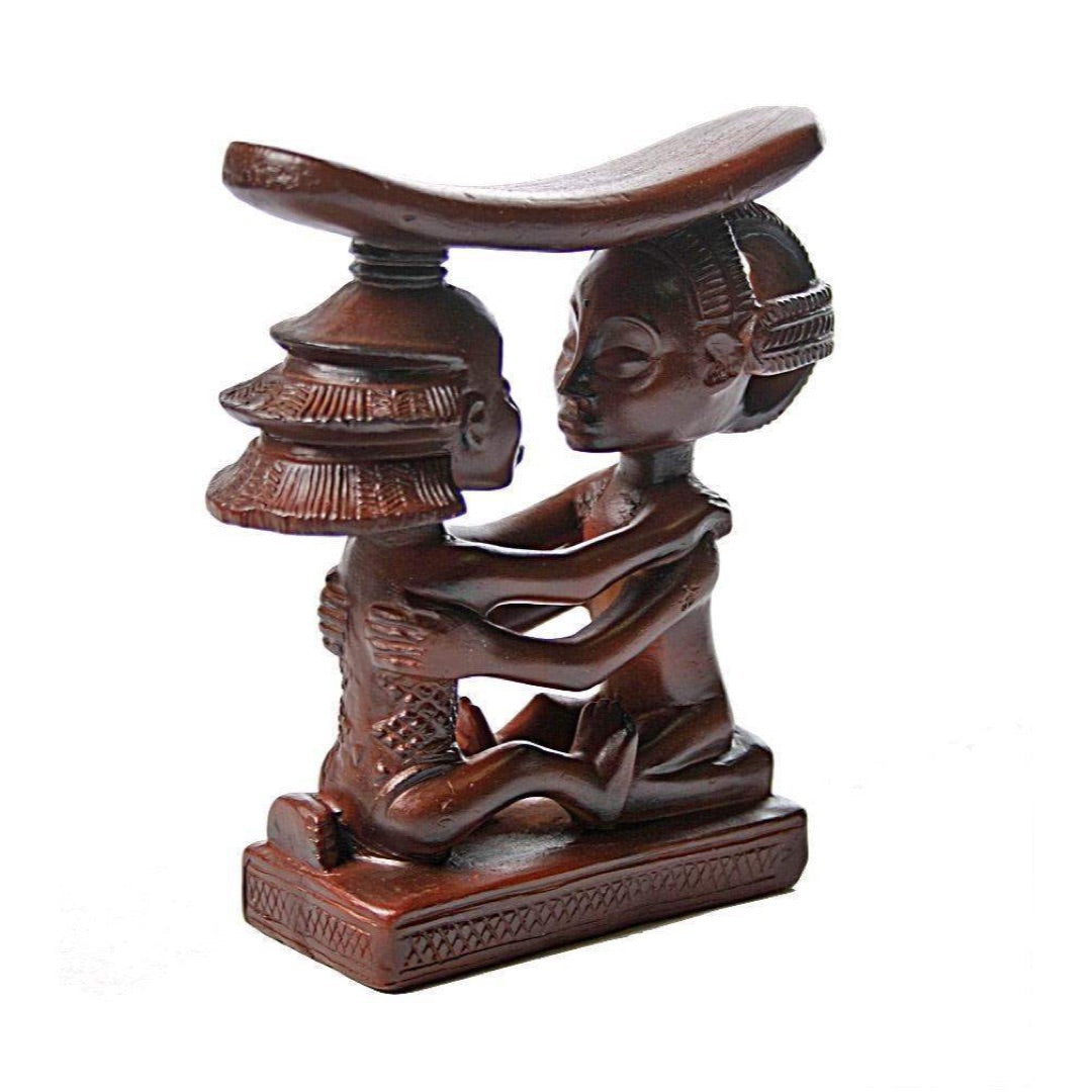 Three-quarter view of Luba couple headrest AFR04, man and woman with elaborate carved hairstyles facing each other, arms intertwined