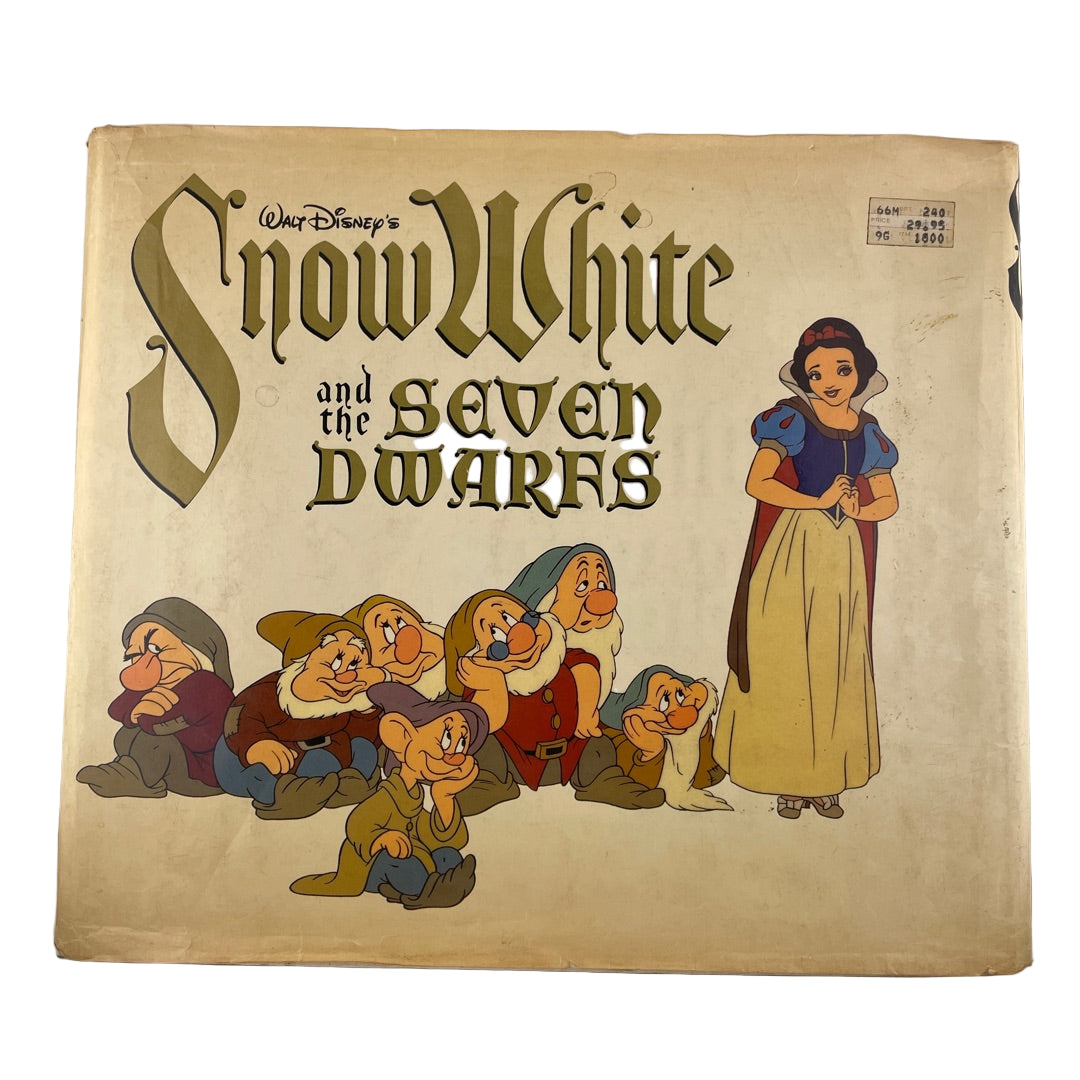 Vintage 'Snow White and the Seven Dwarfs' book cover with animated characters.