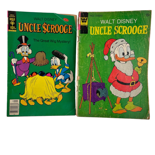 Two vintage Walt Disney Uncle Scrooge comic books on a white background