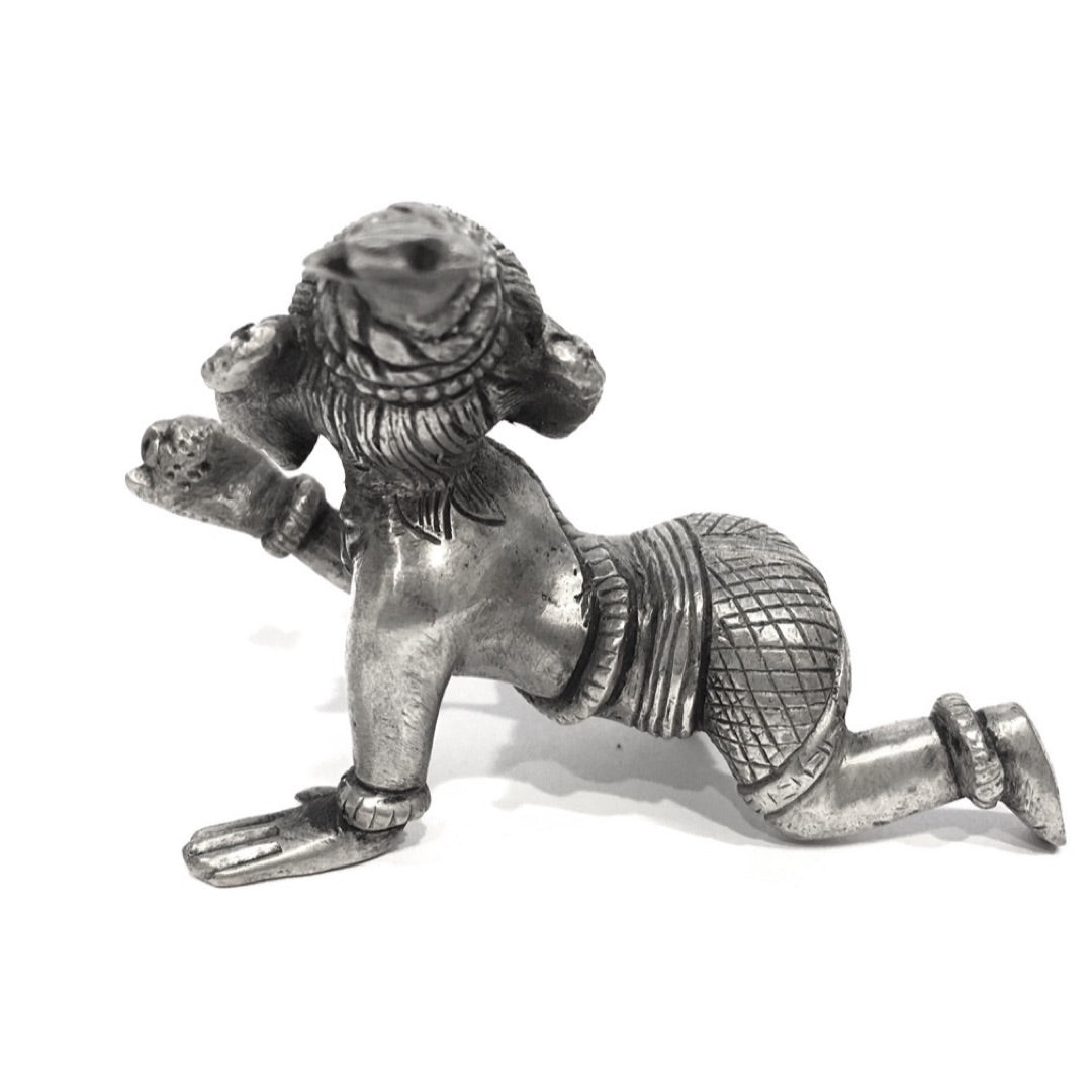 Rear view of baby Ganesh statue with serpent sash and crosshatched dhoti