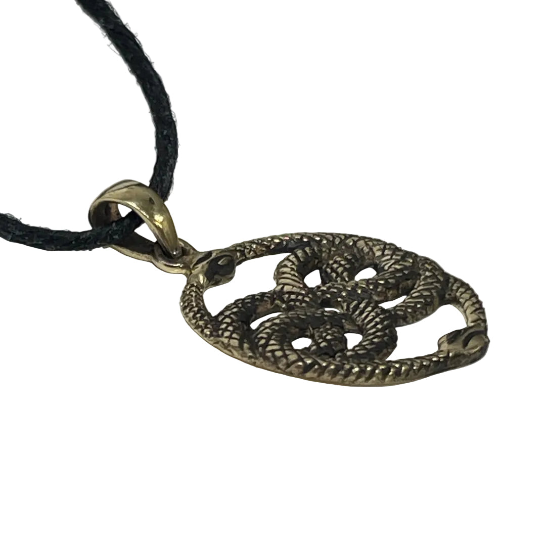 A coiled snake pendant necklace with textured metallic detailing, attached to a black cord, shown on a plain light background.