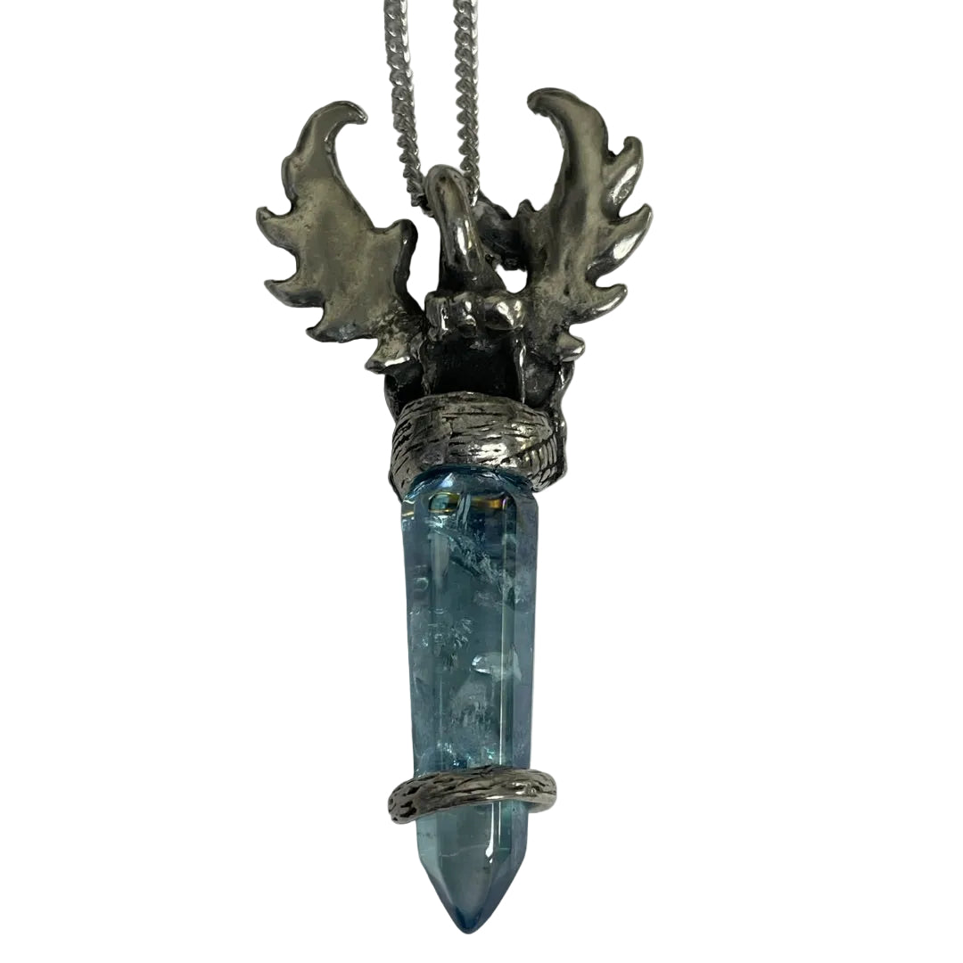 A silver-toned lobster claw pendant necklace featuring a clear blue tumbled crystal point wrapped in textured silver bands, suspended from a silver chain on a plain light gray background.