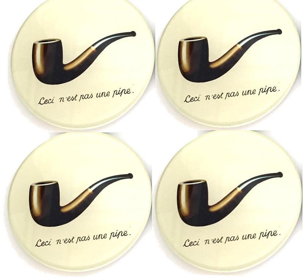 Set of four round coasters with pipe illustration and 'Ceci n'est pas une pipe.' text.