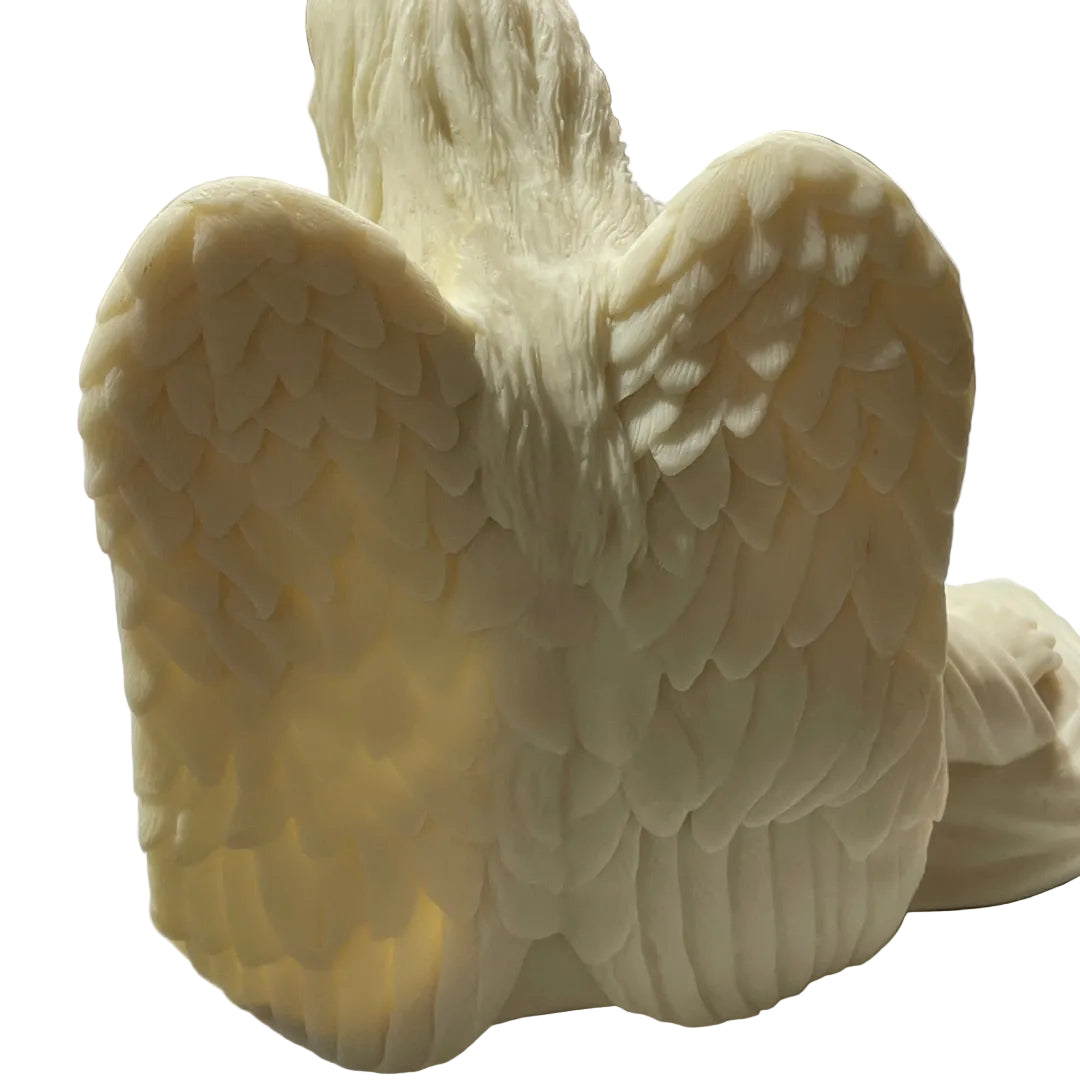 angel wing sculpture, shown from a close-up angle highlighting the detailed layer-by-layer texture of the wings.