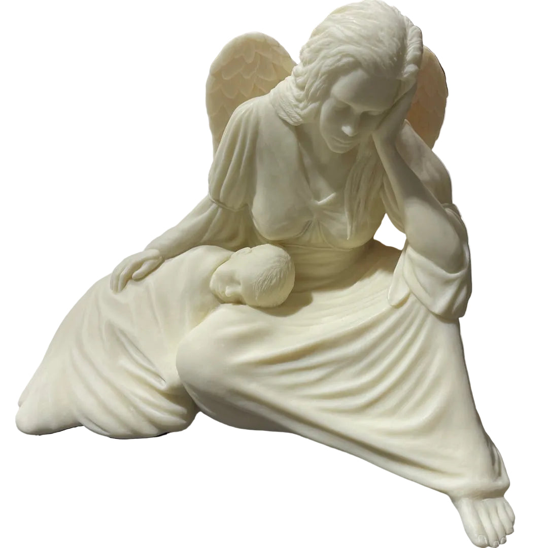 An ivory-colored angel statue seated and cradling a baby