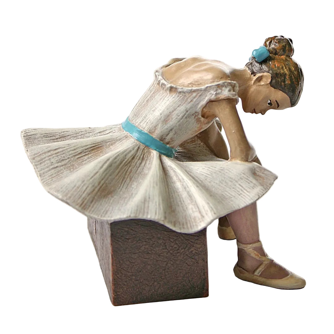 Close detail of Degas ballerina waiting statue showing facial expression of fatigue, hand positioning toward ankle, and sculptural mastery of fabric and form.