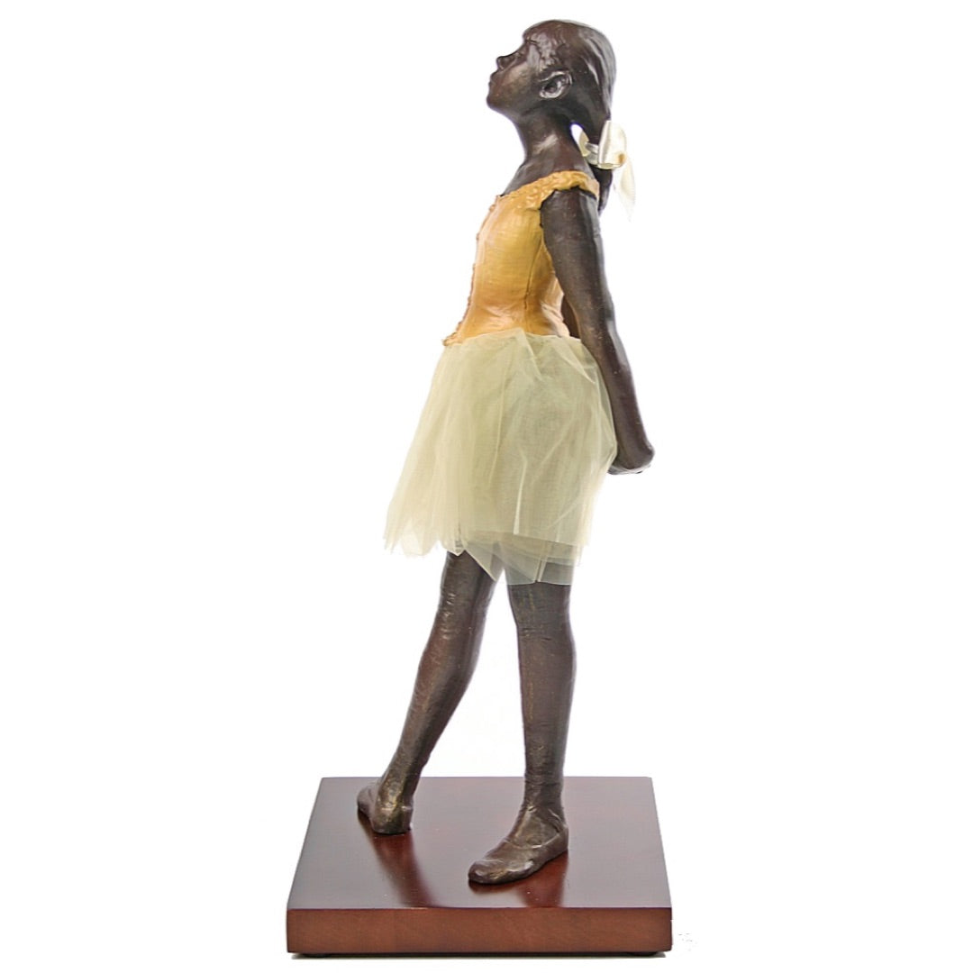 Side view Edgar Degas Little Dancer museum replica with cloth skirt.