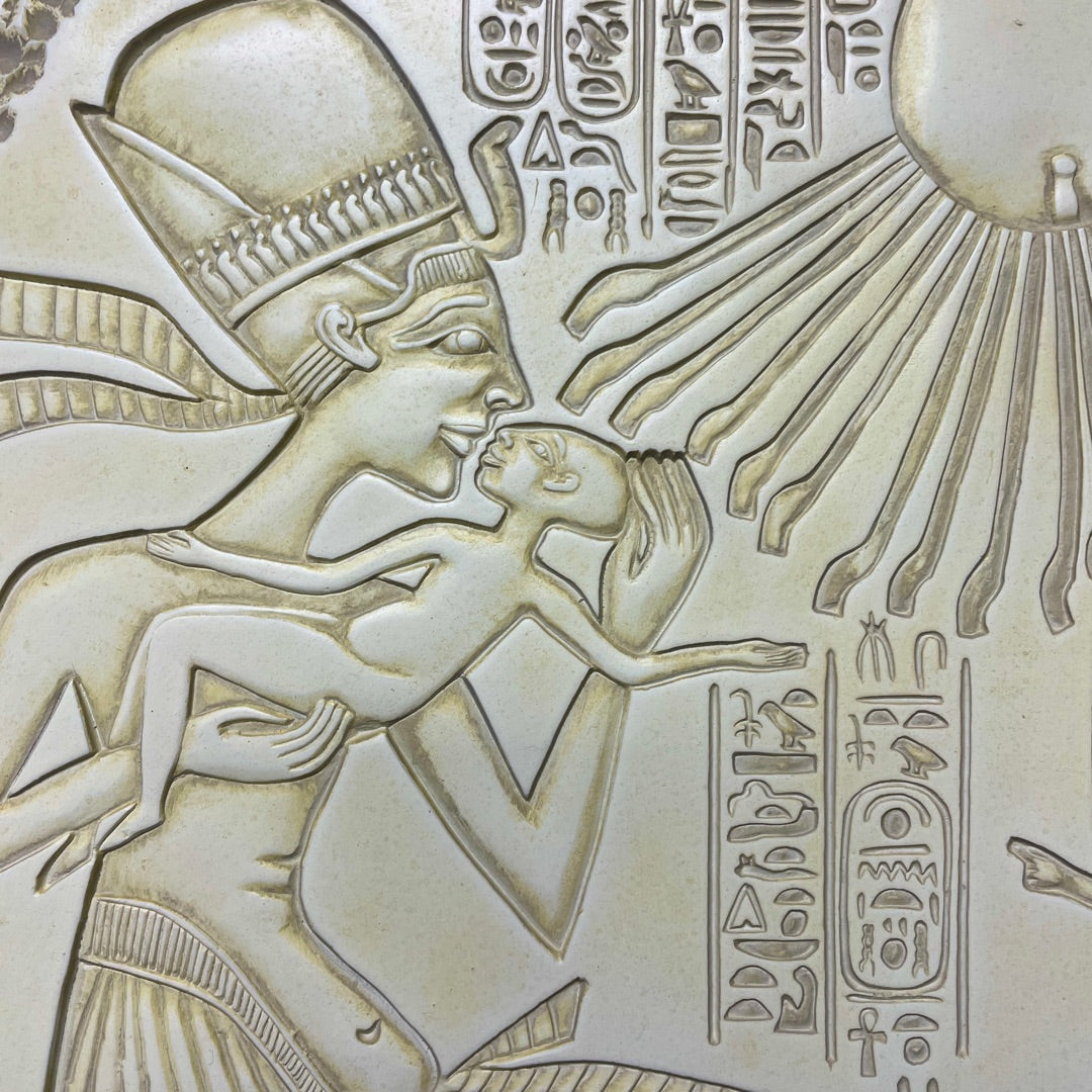 Carved stone relief of an Egyptian deity with hieroglyphs