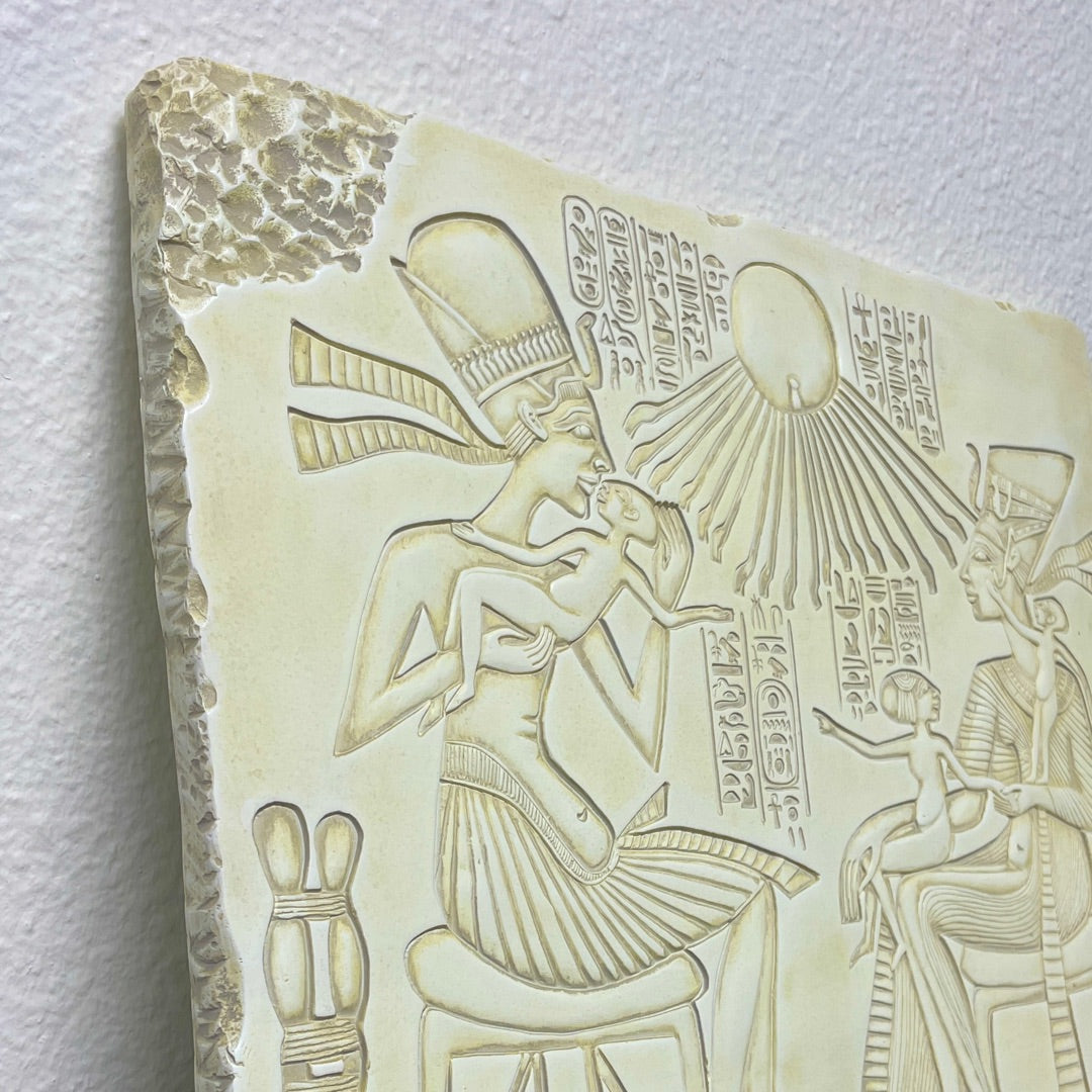 Carved stone slab with ancient Egyptian hieroglyphics and figures on a white background