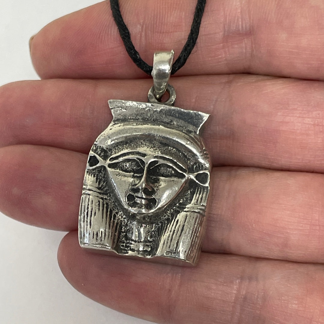 Hathor pendant shown in hand for scale