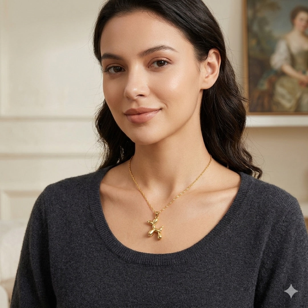 Balloon Dog pendant on gold necklace shown on a model