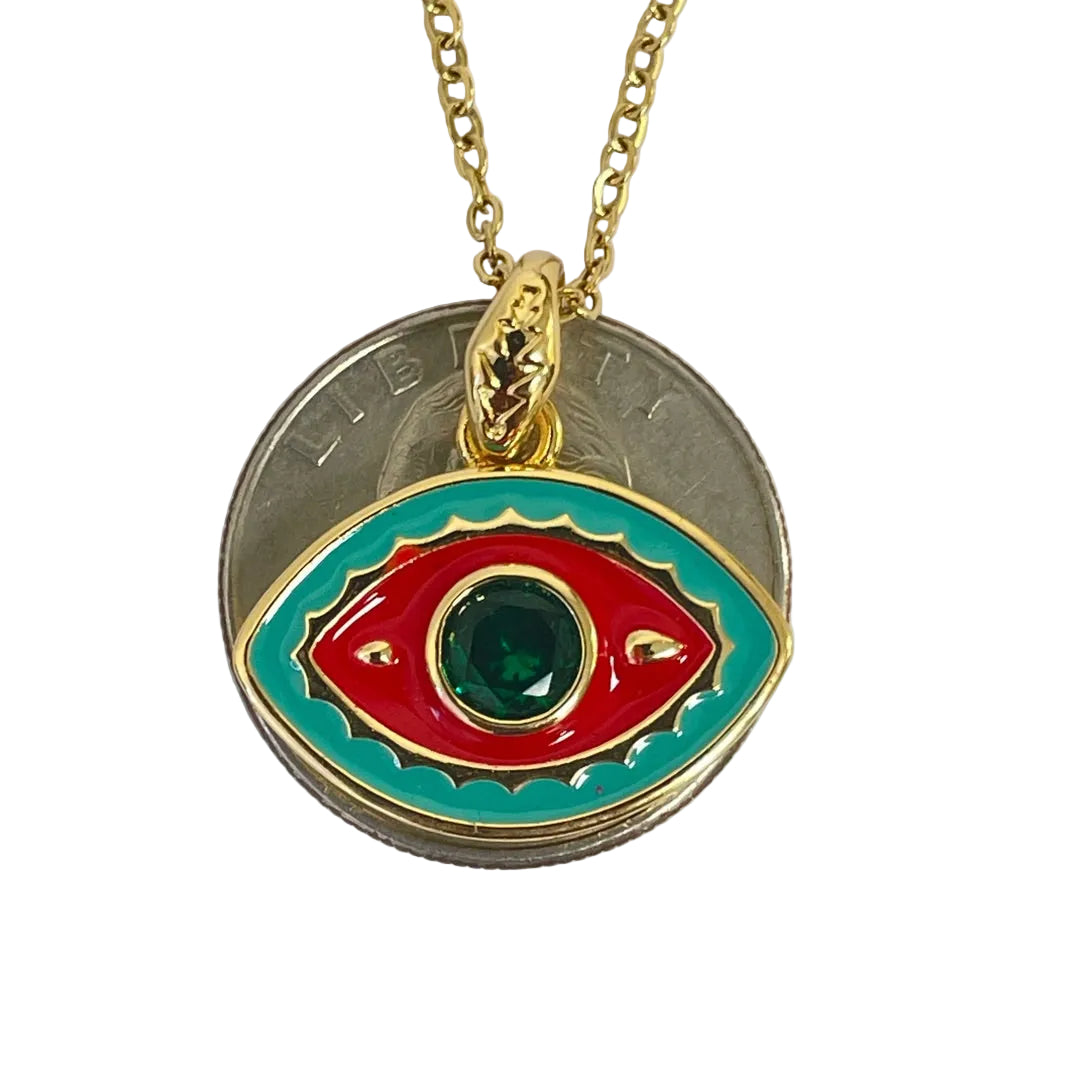 Gold plated evil eye pendant with vibrant enamel colors next to quarter for scale