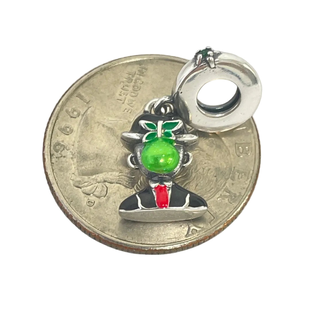 Magritte jewelry charm with scale next to quarter