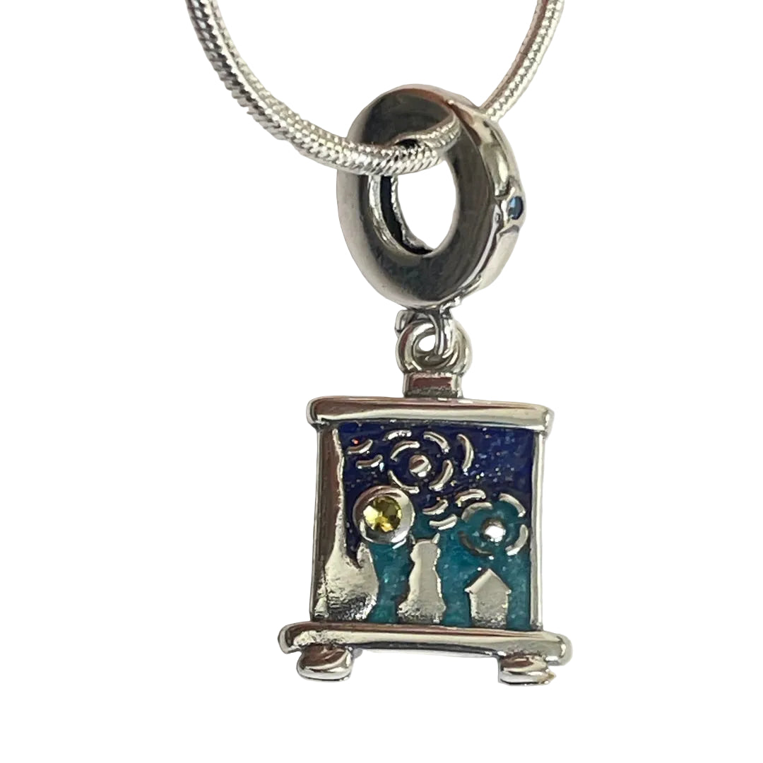 Close-up of teal enamel figures and citrine gemstone accents