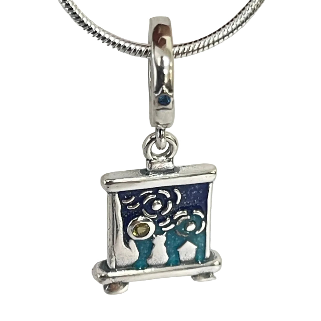 Front face of Van Gogh charm showing deep blue sky and brushstroke design