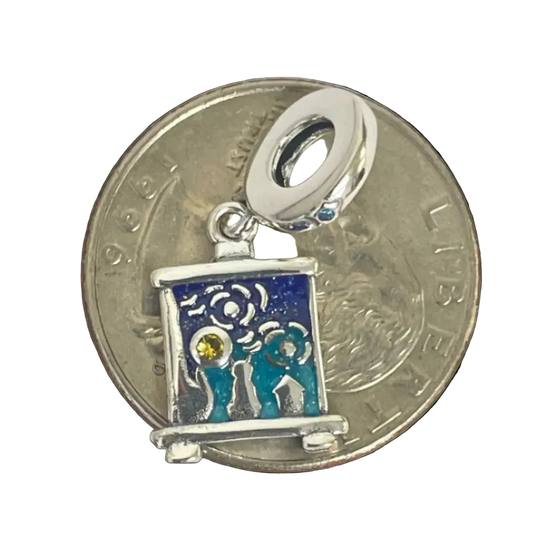 Rectangle silver charm featuring swirling patterns and silhouetted cypress tree