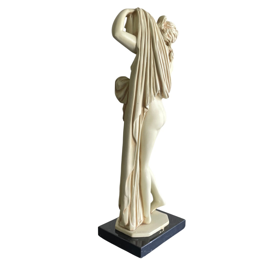 Back view of the Greek goddess statue and draped robe