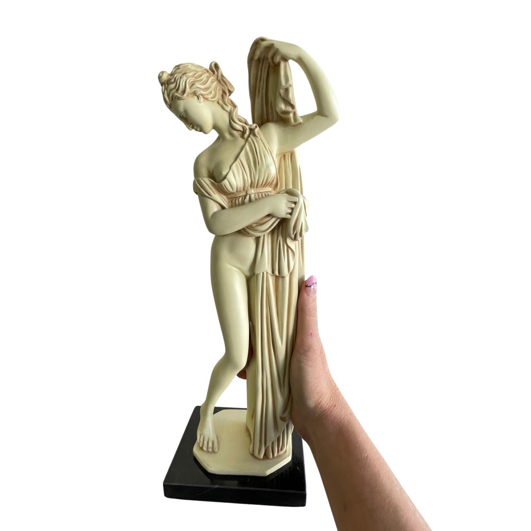 view of the Greek goddess statue held in hand for scale