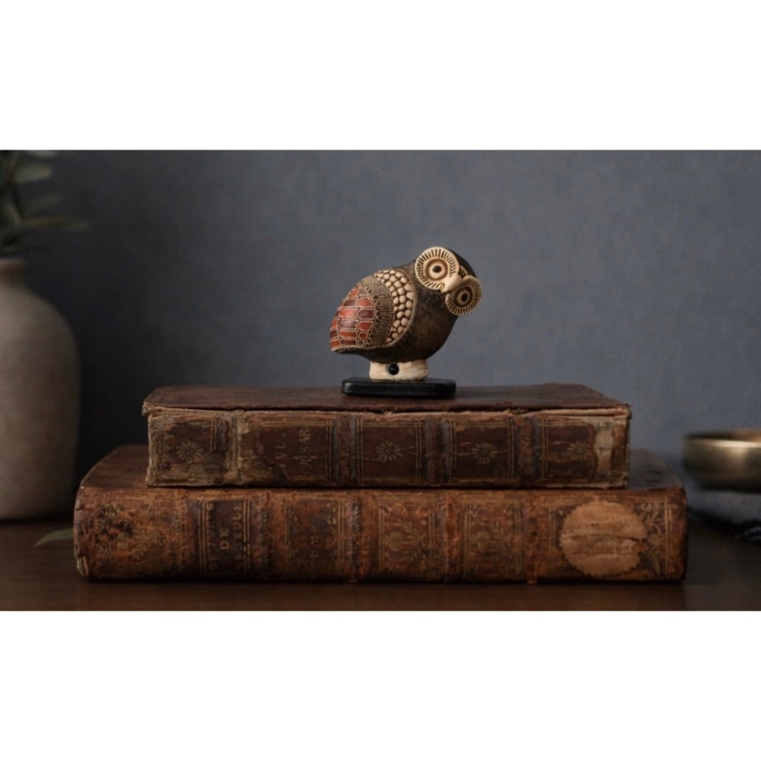 Ancient Greek owl miniature aryballos displayed on antique books, demonstrating 2-inch height scale and ideal shelf or cabinet placement for collectors.