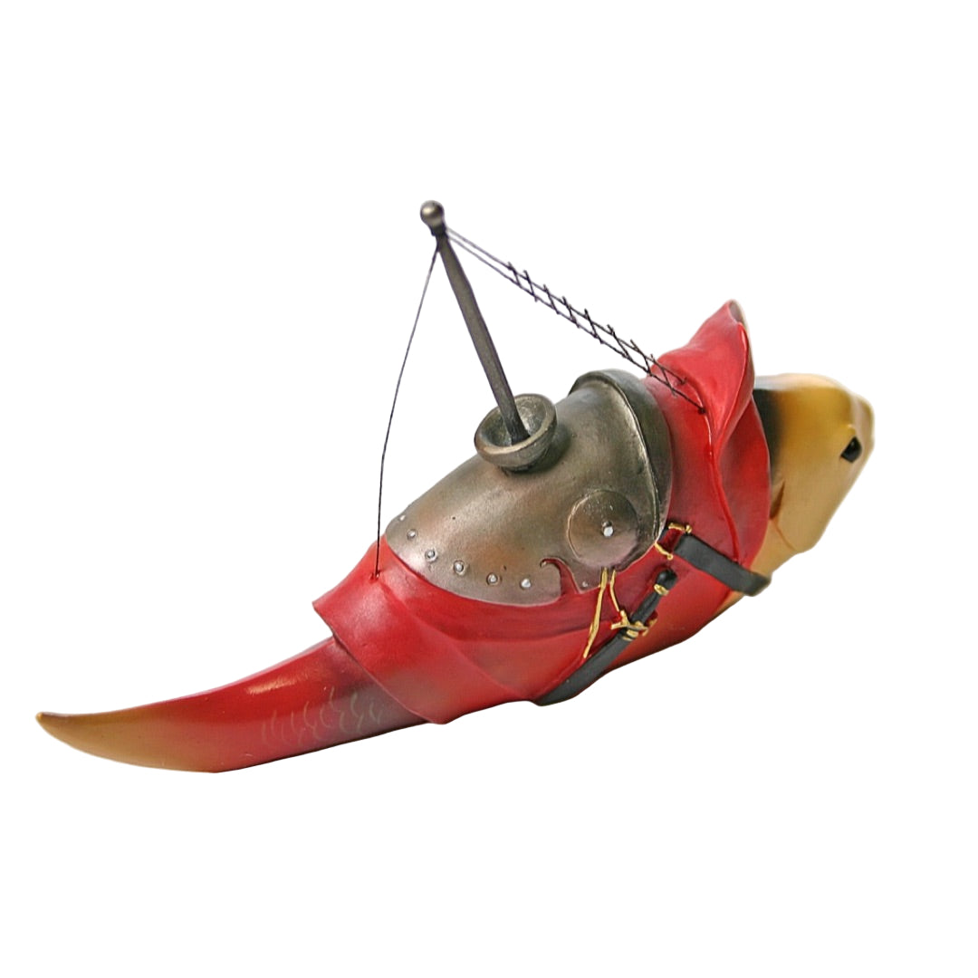 Close-up of whimsical boat-like fish sculpture with mast and painted medieval colors.