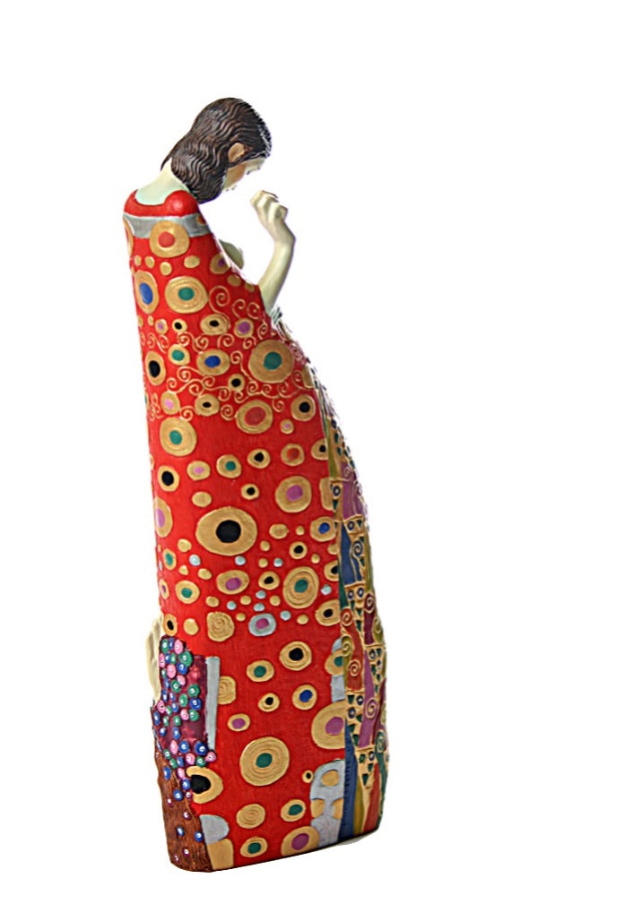 Side view of Klimt Hope sculpture showing nude pregnant form with vivid patterns.