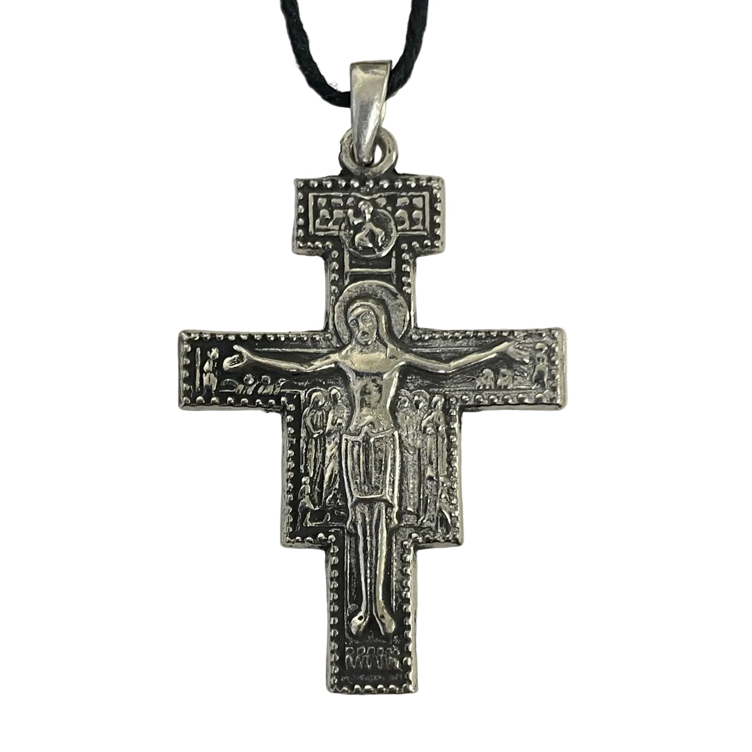 A silver-toned Orthodox Christian cross pendant featuring a detailed depiction of Jesus Christ on the cross, hanging from a black cord against a plain light background.
