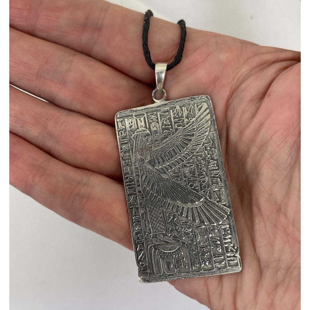 Maat pewter pendant shown for scale held in a hand