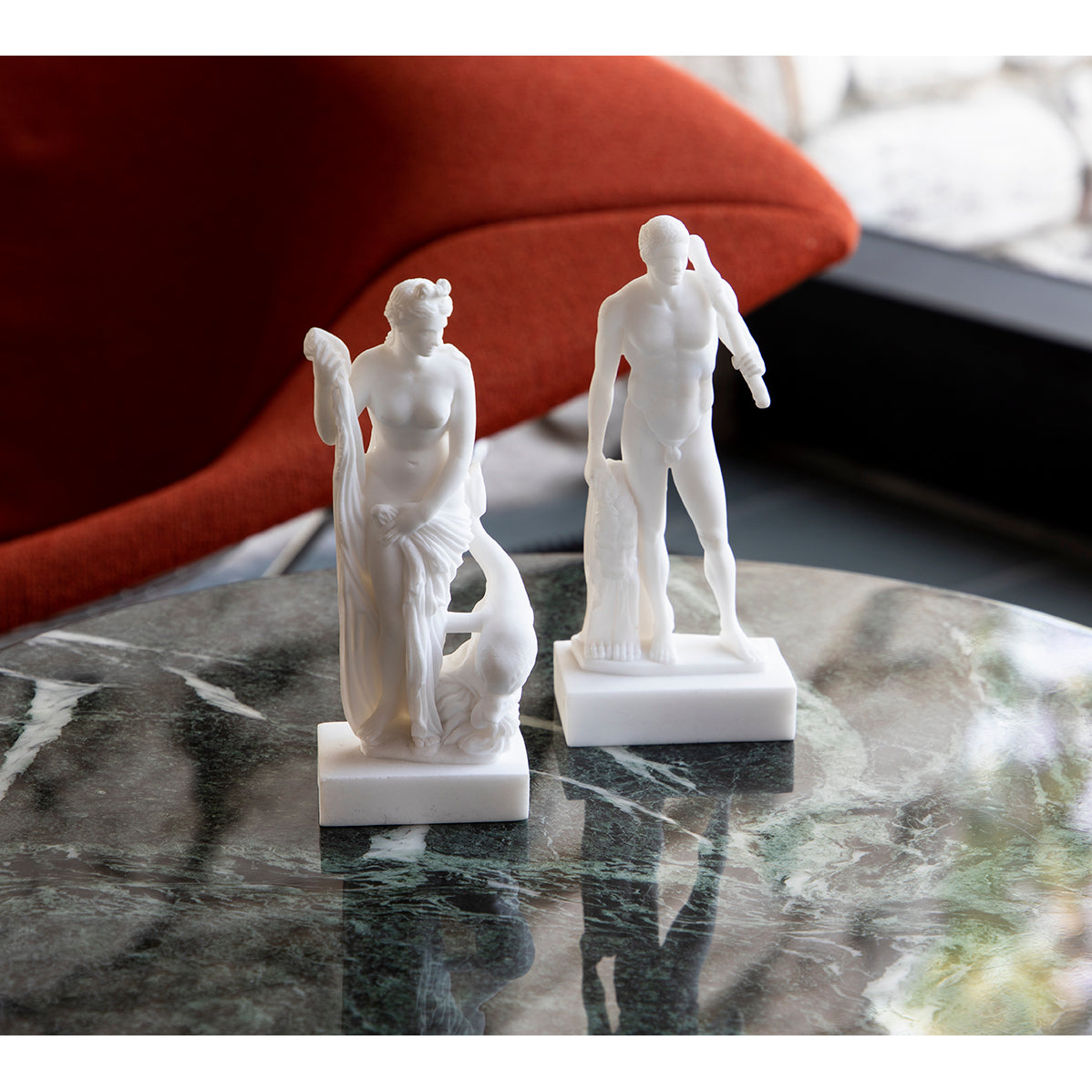 White bonded marble Venus figure enfolding in drapery with dolphin supporting base, 7 inch classical sculpture reproduction