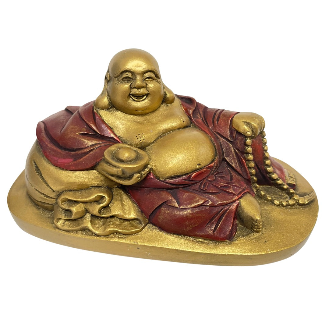 Gold and red reclining Happy Buddha statue, Budai resting on his sack, front view