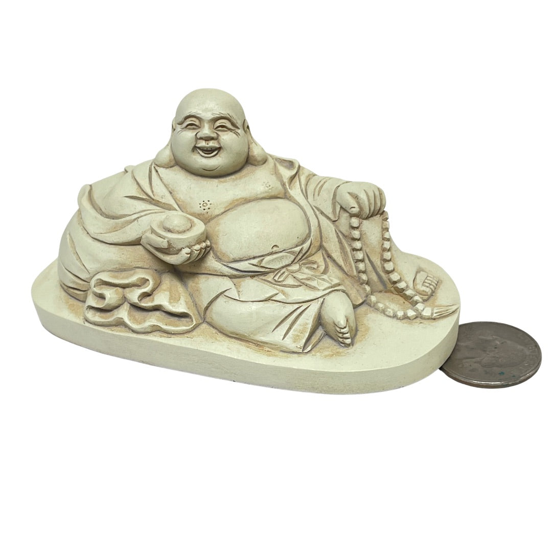 Buddha next to a quarter for scale