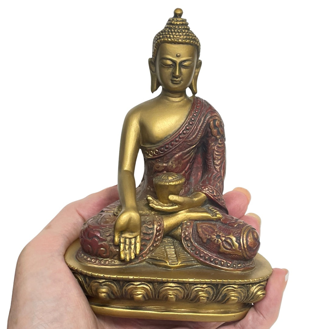 Buddha statue in a hand for scale