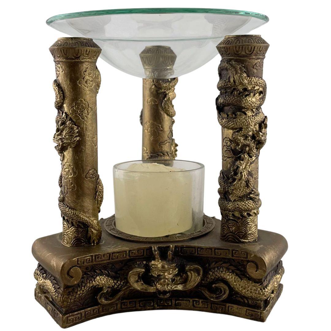 Bronze Asian dragon incense burner with ornate carved columns and glass dish on top.