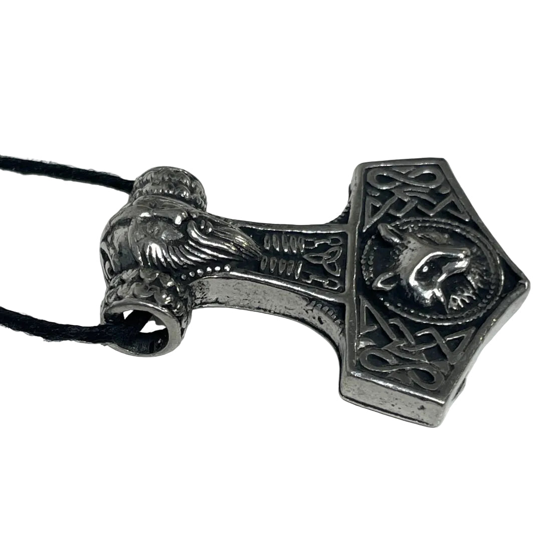 An engraved silver-toned Viking-style hammer pendant on a black cord, photographed on a plain light background.