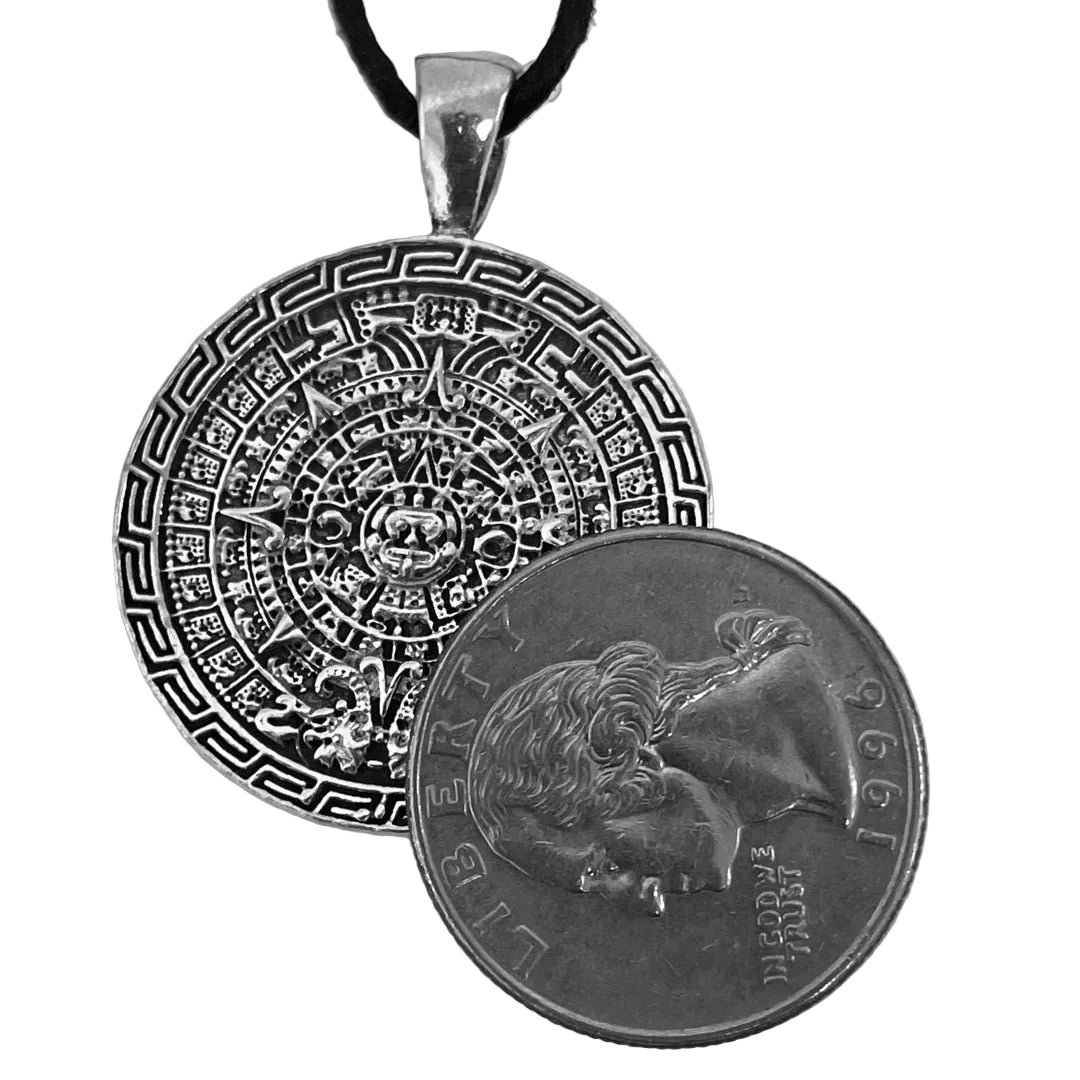 Aztec Sun Stone pewter pendant shown for scale next to a quarter