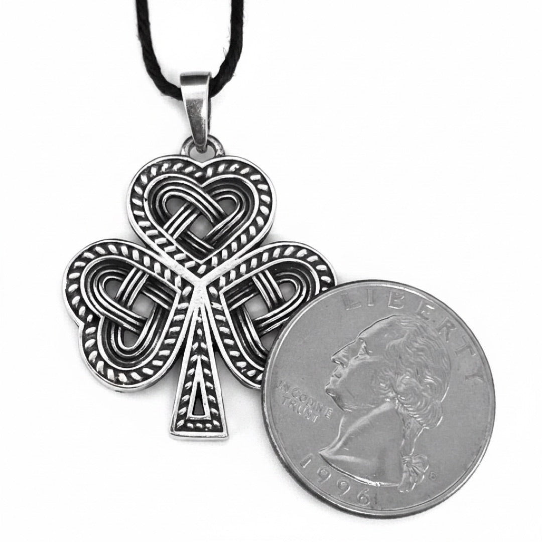 Shamrock Celtic knot pendant shown for scale next to a quarter
