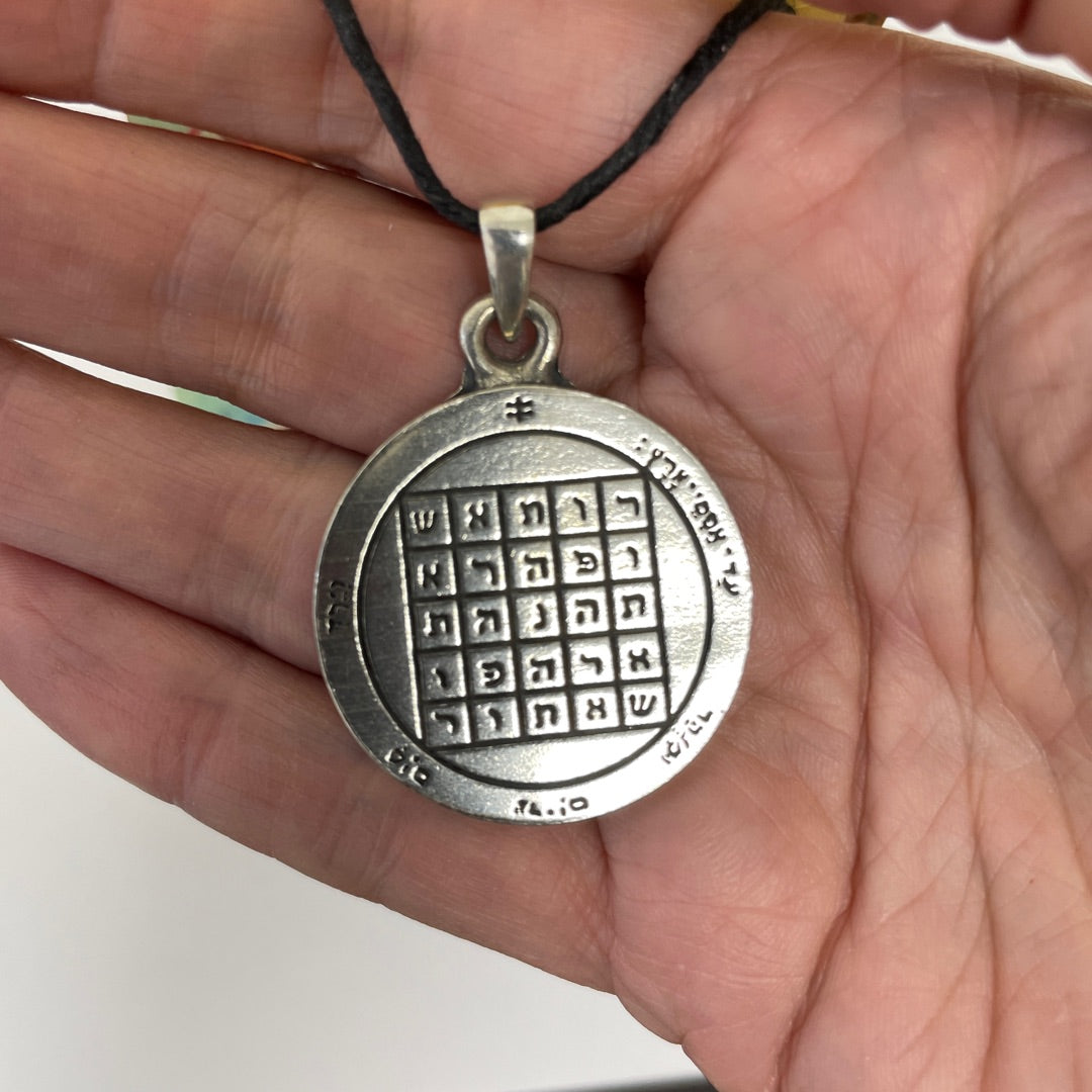 Second Pentacle of Saturn pewter pendant shown for scale in a hand