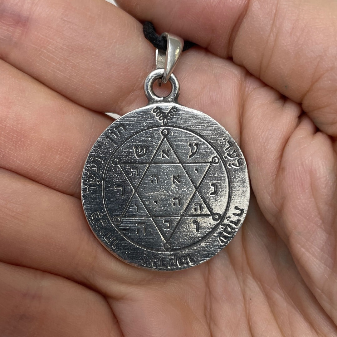 Close view of the Hebrew angel names ringing the First Pentacle of Jupiter in pewter