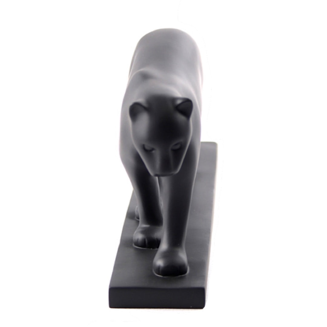 Pompon black panther walking sculpture with sleek, simplified silhouette.