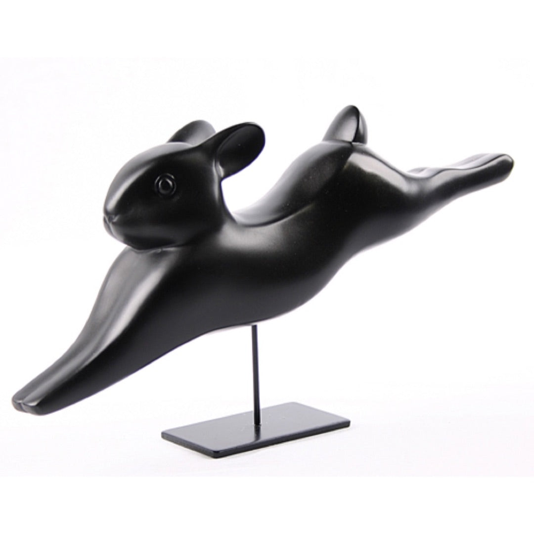Pompon Lapin Courant sculpture with rabbit in mid-stride motion.