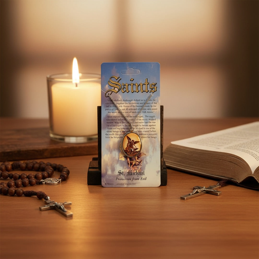 St Michael Necklace near rosary, bible and candle