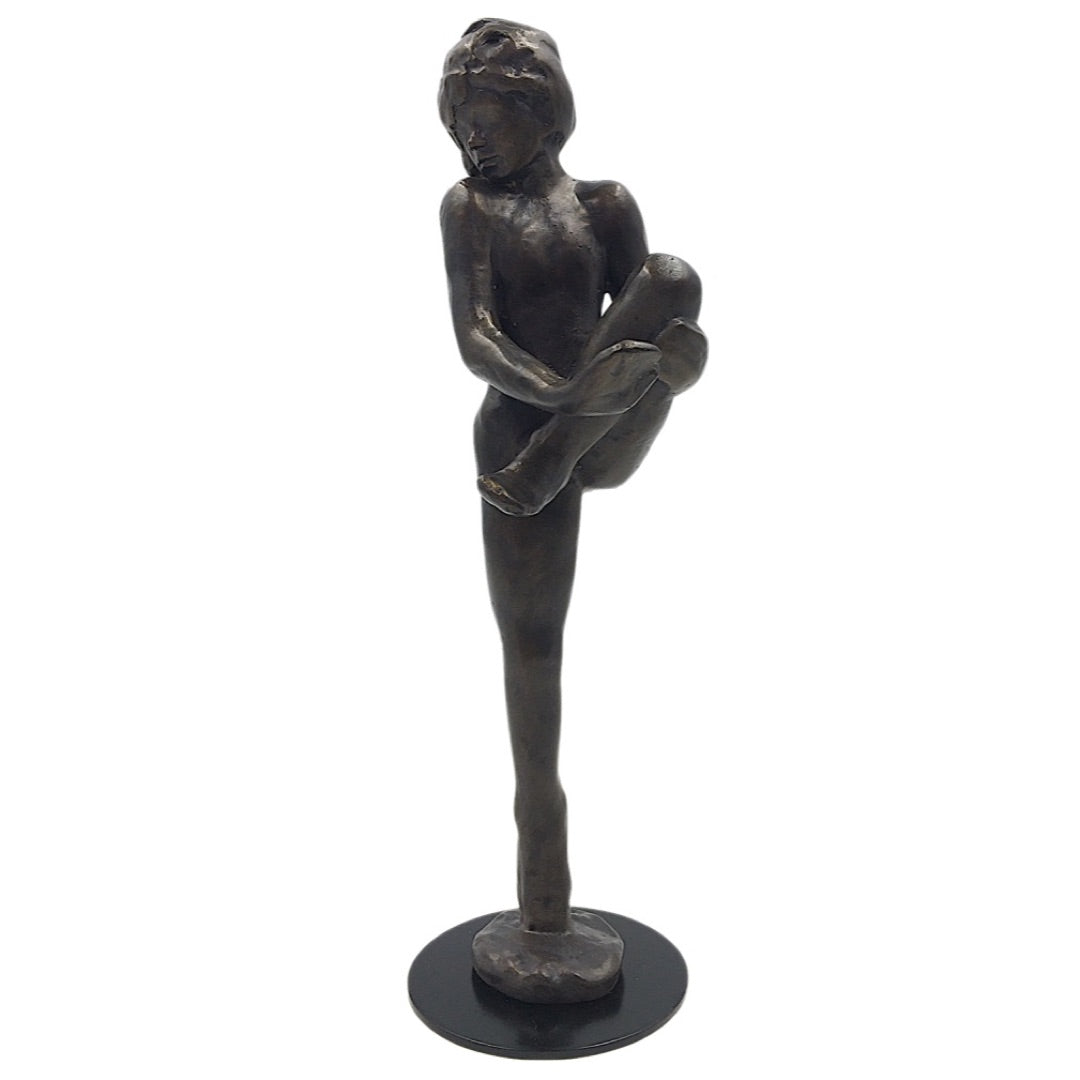 Bronze-finish Rodin dancer sculpture showing leg raised to chest, Parastone replica.