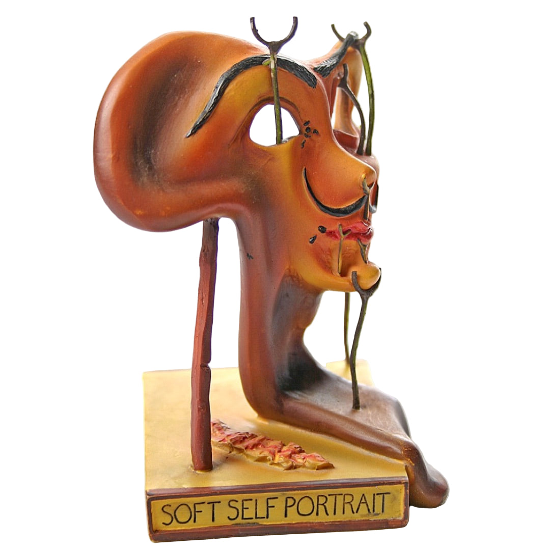 Side view of Dalí Self Portrait statue with melting facial profile.