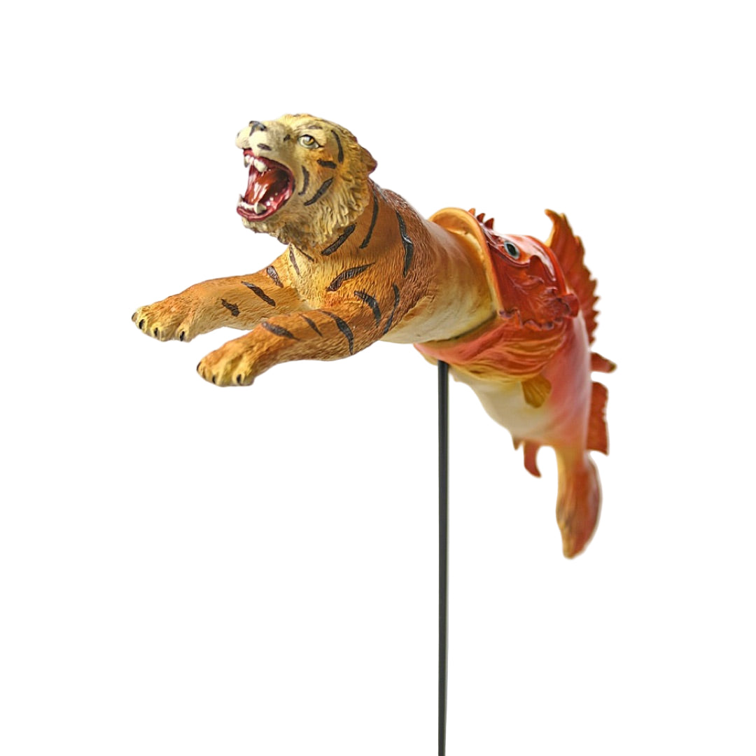 Side view of Dalí dream tiger statue with arched fish and metal stand.